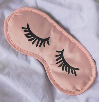 eye mask with cartoon eyes sewn on it